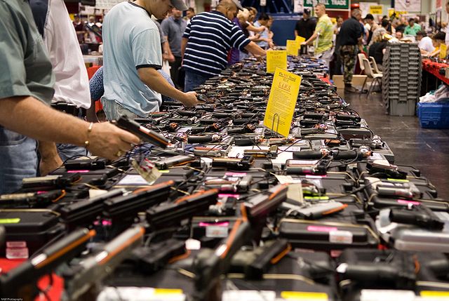 Dozens of handguns at a gun show.