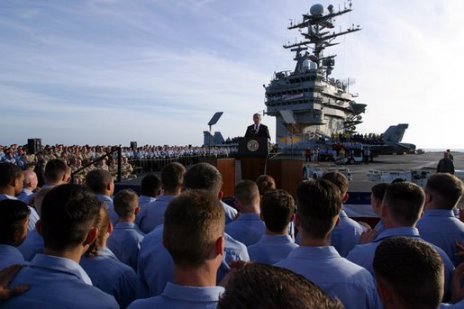 President George W. Bush (43) addressing sailors on board the
          U.S.S. Lincoln in 2004.